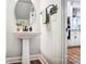 Powder room featuring a pedestal sink and modern fixtures at 1112 Drummond Ave, Charlotte, NC 28205