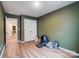 Bedroom with hardwood floors, a double door closet, green walls and a robotic litter box at 1112 Drummond Ave, Charlotte, NC 28205