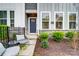 Welcoming home with well maintained front yard featuring stone accents and outdoor seating area at 1112 Drummond Ave, Charlotte, NC 28205