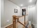 Hallway with hardwood floors and wooden railing at 1112 Drummond Ave, Charlotte, NC 28205