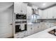 Updated kitchen featuring stainless appliances and gas cooktop on white countertops at 1112 Drummond Ave, Charlotte, NC 28205