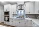 Bright kitchen featuring stainless appliances, white cabinets, and light backsplash at 1112 Drummond Ave, Charlotte, NC 28205