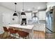 Modern kitchen with stainless steel appliances, white cabinetry, and a large center island at 1112 Drummond Ave, Charlotte, NC 28205