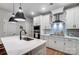 Modern kitchen with stainless steel appliances, white cabinets, and sleek range hood at 1112 Drummond Ave, Charlotte, NC 28205