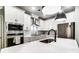 Modern kitchen with stainless appliances, white cabinets and island with sink at 1112 Drummond Ave, Charlotte, NC 28205
