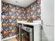 Laundry room with modern washer and dryer set and vibrant floral wallpaper at 1112 Drummond Ave, Charlotte, NC 28205