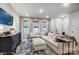 Cozy living room featuring a large sectional couch, stylish rug, and ample natural light at 1112 Drummond Ave, Charlotte, NC 28205