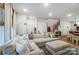 Inviting living room featuring an oversized sectional, hardwood floors, and modern lighting at 1112 Drummond Ave, Charlotte, NC 28205