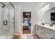 Bright main bathroom showing double vanity, glass shower, and ensuite bedroom at 1112 Drummond Ave, Charlotte, NC 28205