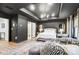 Modern main bedroom with dark walls, tray ceiling, chandelier, and an ensuite bathroom at 1112 Drummond Ave, Charlotte, NC 28205