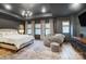 Modern main bedroom with dark walls, tray ceiling, chandelier, sitting area, and patterned rug at 1112 Drummond Ave, Charlotte, NC 28205