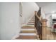 Wooden staircase with white risers and dark banister at 1112 Drummond Ave, Charlotte, NC 28205