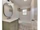 Updated bathroom with designer tile, new lighting, and a modern vanity at 1209 Mount Ulla Hwy, Mooresville, NC 28115