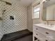 A modern bathroom features a glass shower, decorative tile, and a vanity with marble countertop at 1209 Mount Ulla Hwy, Mooresville, NC 28115