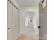 Bright hallway with an arched doorway, white walls, light wood floors, and closet space at 1209 Mount Ulla Hwy, Mooresville, NC 28115