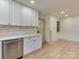 Updated kitchen with white cabinets, stainless appliances, light countertops and wood floors at 1209 Mount Ulla Hwy, Mooresville, NC 28115