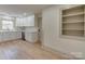 Eat-in kitchen with modern white cabinets, stainless appliances, and hardwood floors at 1209 Mount Ulla Hwy, Mooresville, NC 28115