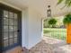 A charming porch with patterned tile, a hanging lantern, and lush ferns creates a welcoming entrance at 1209 Mount Ulla Hwy, Mooresville, NC 28115