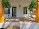 Close-up of a cozy front porch featuring patterned flooring, stylish railings, and lush hanging ferns at 1209 Mount Ulla Hwy, Mooresville, NC 28115