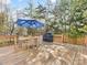 Open back deck with wooden railings, grill, and table, offering an ideal space for outdoor gatherings at 1210 Sewickley Dr, Charlotte, NC 28209