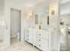 This updated bathroom features a double vanity, marble floors, and modern fixtures at 1210 Sewickley Dr, Charlotte, NC 28209