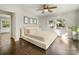 Bright bedroom features hardwood floors, a ceiling fan, and ample natural light from a large window at 1210 Sewickley Dr, Charlotte, NC 28209