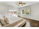 This airy bedroom boasts hardwood floors, two windows, and a ceiling fan, offering a tranquil retreat at 1210 Sewickley Dr, Charlotte, NC 28209