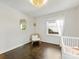 This light-filled bedroom boasts hardwood floors, a gold mirror, and a white baby crib at 1210 Sewickley Dr, Charlotte, NC 28209