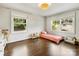This cozy bedroom is filled with natural light from two large windows and hardwood floors at 1210 Sewickley Dr, Charlotte, NC 28209