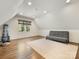 Bright bonus room with hardwood floors, futon, and window allowing for ample natural light at 1210 Sewickley Dr, Charlotte, NC 28209