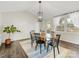 Bright dining room featuring hardwood floors, an oval table, and a modern chandelier at 1210 Sewickley Dr, Charlotte, NC 28209