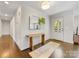 Welcoming foyer with a hardwood floor, stylish mirror, wooden table, and a view of the home's entrance at 1210 Sewickley Dr, Charlotte, NC 28209