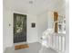 Inviting front porch with black front door, 'Welcome Home' mat, and a glimpse of the home's exterior at 1210 Sewickley Dr, Charlotte, NC 28209