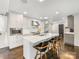 Bright kitchen features a marble island, stainless steel appliances, and dark hardwood flooring at 1210 Sewickley Dr, Charlotte, NC 28209