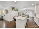 The Kitchen features marble island with seating and bright white cabinetry at 1210 Sewickley Dr, Charlotte, NC 28209