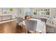 Open-concept living room featuring hardwood floors, TV and seating, and natural light from large windows at 1210 Sewickley Dr, Charlotte, NC 28209