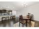 Dining area adjacent to the kitchen featuring a wooden table, seating for four, and modern lighting at 1212 Croft Dr, Fort Mill, SC 29708