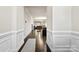 Welcoming hallway featuring elegant wainscoting, hardwood floors and a view into the open-concept living space at 1212 Croft Dr, Fort Mill, SC 29708