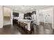 Open-concept kitchen boasting a large island with seating, modern appliances, and dark wood cabinetry at 1212 Croft Dr, Fort Mill, SC 29708