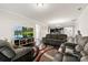 Spacious living room featuring comfortable seating, a large television, and an open layout to the kitchen at 1212 Croft Dr, Fort Mill, SC 29708