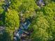 Lush tree canopy surrounds the property in this aerial view, offering a sense of seclusion and natural beauty at 1220 Oakwood Ave, Gastonia, NC 28052