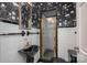 Unique bathroom features a black sink, toilet, and vintage floral wallpaper at 1220 Oakwood Ave, Gastonia, NC 28052