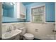 Cozy bathroom with classic blue and white tile, updated fixtures, and window at 1220 Oakwood Ave, Gastonia, NC 28052