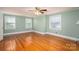 Large bright bedroom with hardwood flooring, neutral paint, and several windows at 1220 Oakwood Ave, Gastonia, NC 28052