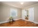 Bright bedroom featuring hardwood floors, neutral walls, and closet with mirrored door at 1220 Oakwood Ave, Gastonia, NC 28052