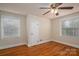Bedroom featuring hardwood floors, two windows, ceiling fan and neutral paint at 1220 Oakwood Ave, Gastonia, NC 28052