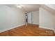 Neutral bedroom featuring hardwood flooring and a doorway leading to another room at 1220 Oakwood Ave, Gastonia, NC 28052