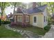 Charming home featuring a brick and siding exterior, complemented by a stone walkway and vibrant flower bushes at 1220 Oakwood Ave, Gastonia, NC 28052