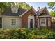Charming brick home featuring a well-manicured front yard with mature landscaping at 1220 Oakwood Ave, Gastonia, NC 28052