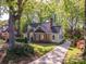Inviting two-story home with brick and siding, a well-manicured lawn, and a driveway leading to a beautiful property at 1220 Oakwood Ave, Gastonia, NC 28052